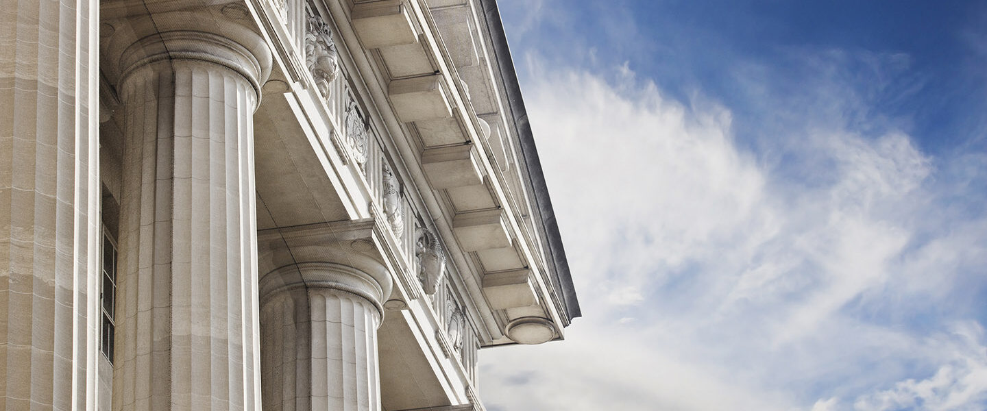 A close up look at a courthouse or government building with lots of copy space to the right