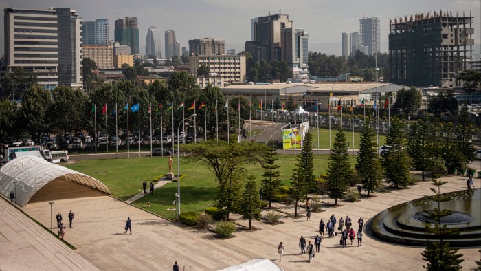 People walk towards the entrance of the African Union headquarters in Addis Ababa