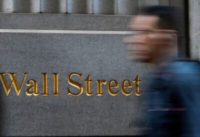 Blurred image of people walking past the New York Stock Exchange